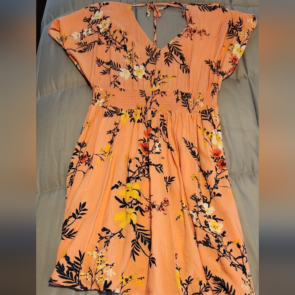 Bebop Jr dress v- neck front and back and tie back.  Just above knee length.